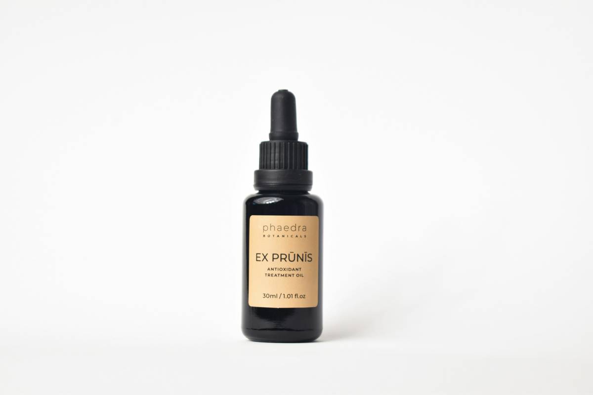 woman applying exfoliating product chemical exfoliant aha code to face with measured precision